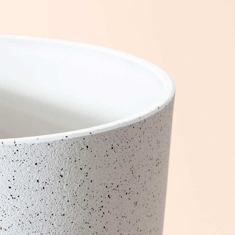 A close up of speckled white planter, showing its concrete texture and large dimension in 14.2 inches.