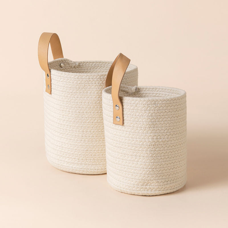 A pair of tote beige baskets in different sizes, made of natural cotton rope.