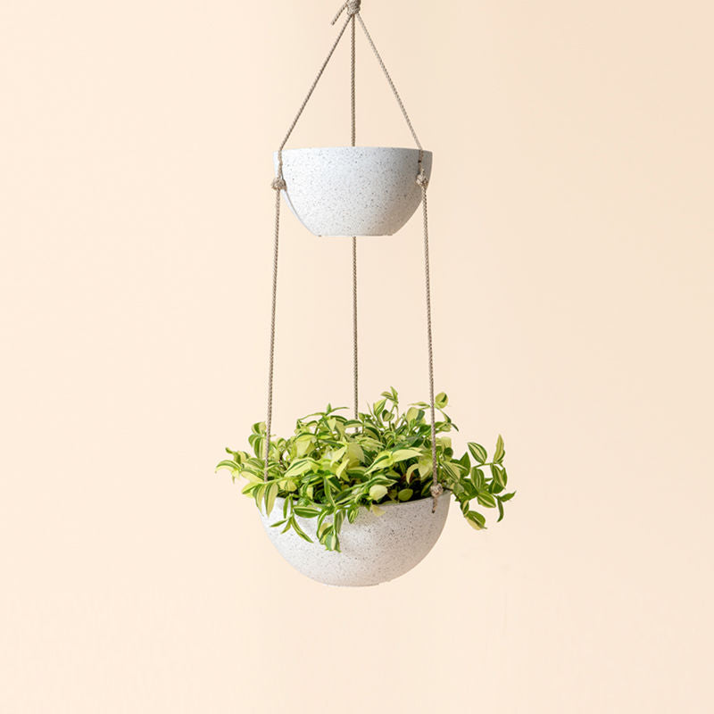 A full view of two-tier speckled white hanging planter, made from recyclable plastic and natural stone powders.