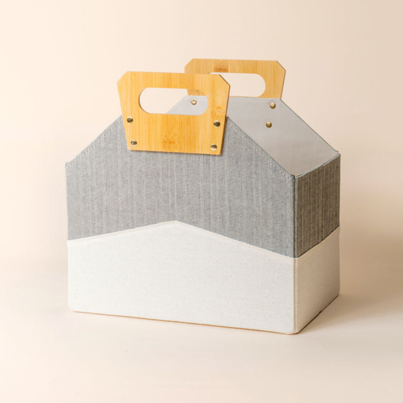 A display of white and gray storage basket in tiny house shape.