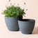 A set of two weathered gray planter pots, made from recyclable plastic and natural stone powders.