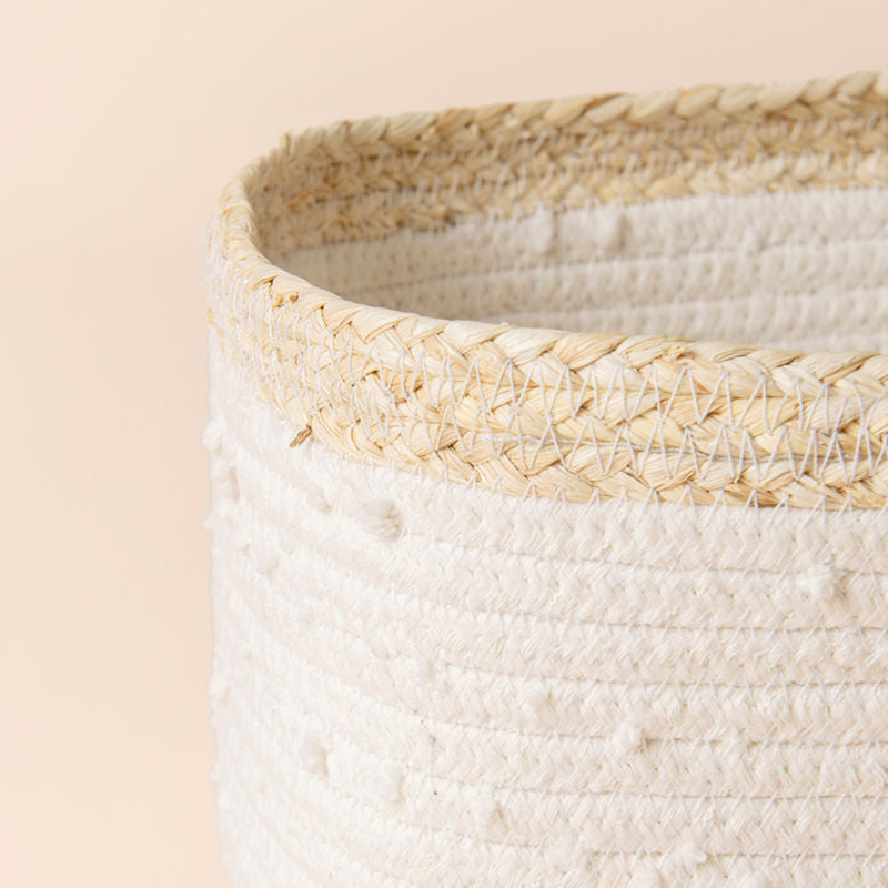 A close up of white rope and corn skin basket, showing its fabric texture and natural material.