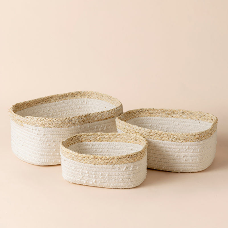 A set of three white storage baskets in different sizes, made of cotton rope and corn skin.