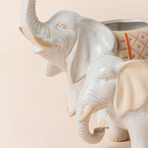 A close-up of the planter set, showing the detailing elephant design and its sleek ceramic finish surface.
