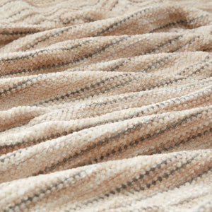 A close-up photo of the chenille throw with striped pattern and tassels ends.
