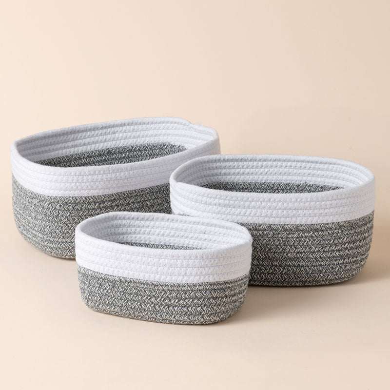 A full view of three white and gray cotton rope baskets in different sizes, showing their dual-colored body.