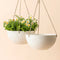 A set of two white 10-inch planters with a honeycomb pattern design. Planters are hanging on the wall with support from ropes.