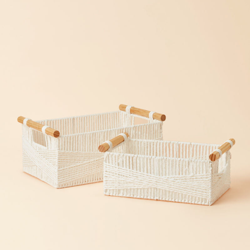 A set of two white rectangular baskets, handwoven with recycled paper ropes and wood handles.