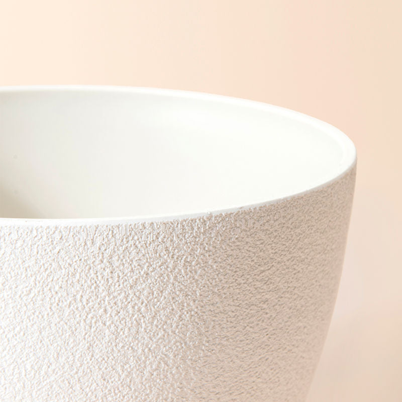 A close up of white tall pot, showing its handmade texture and large dimension in 20 inches.